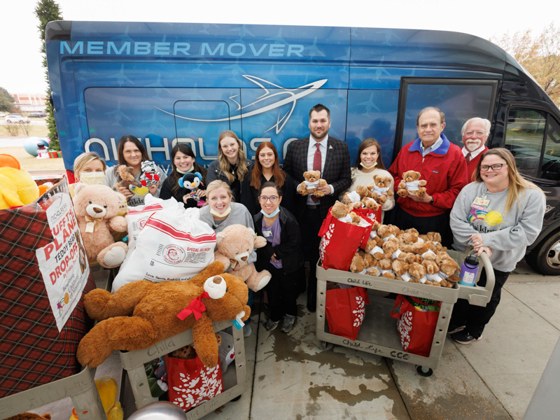 Showing the many bears and other stuffed toys collected by Nicholas Air for Children's of Mississippi patients are, from left, child life specialists Tiffany Key, Pepper Weed-Cooper and Kelsey Clark, Nicholas Air marketing coordinator Abby Carlton, Nicholas Air events coordinator Tate Martin, Nicholas Air President Peder von Harten, child life specialist Cara Williams, Lt. Gov. Delbert Hosemann, driver Joe Walton and child life specialist Ashley Prendez. Joe Ellis/ UMMC Communications 